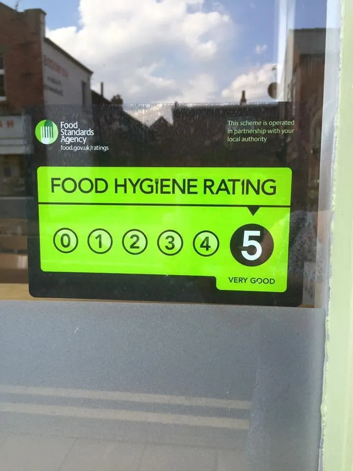Food Standards Agency food hygiene rating sticker showing 5, Very Good, in the cafe window